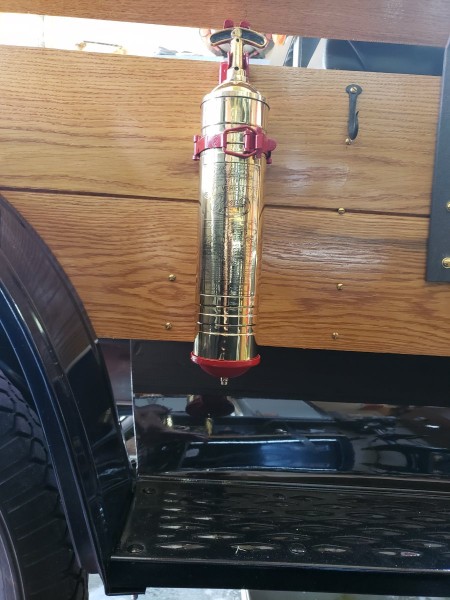 Large extinguisher on side of truck.