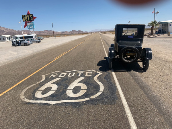 Coupe by Route 66 sign